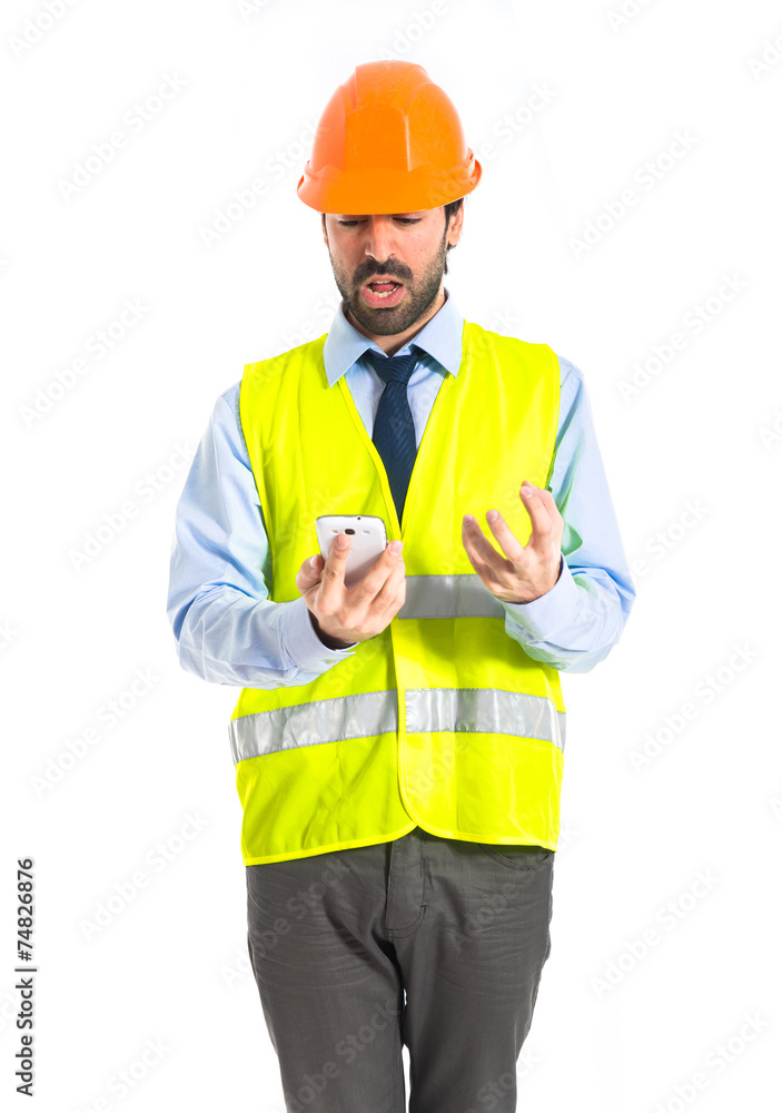 Worker talking to mobile Worker talking to mobile