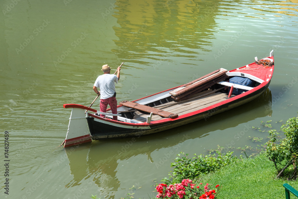 Man in a boat in a river in a summer day
