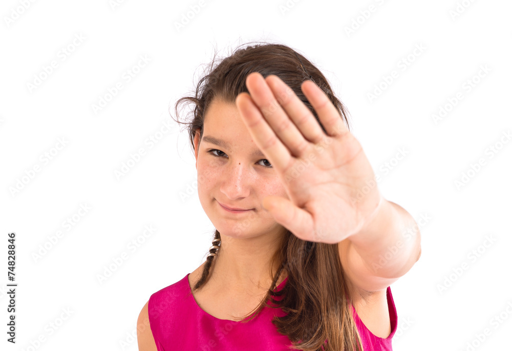 Girl making stop sign over white background Girl making stop sign over white background