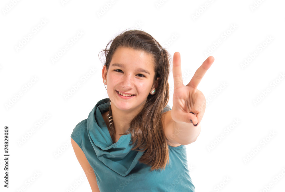 Girl doing victory gesture over white background Girl doing victory gesture over white background