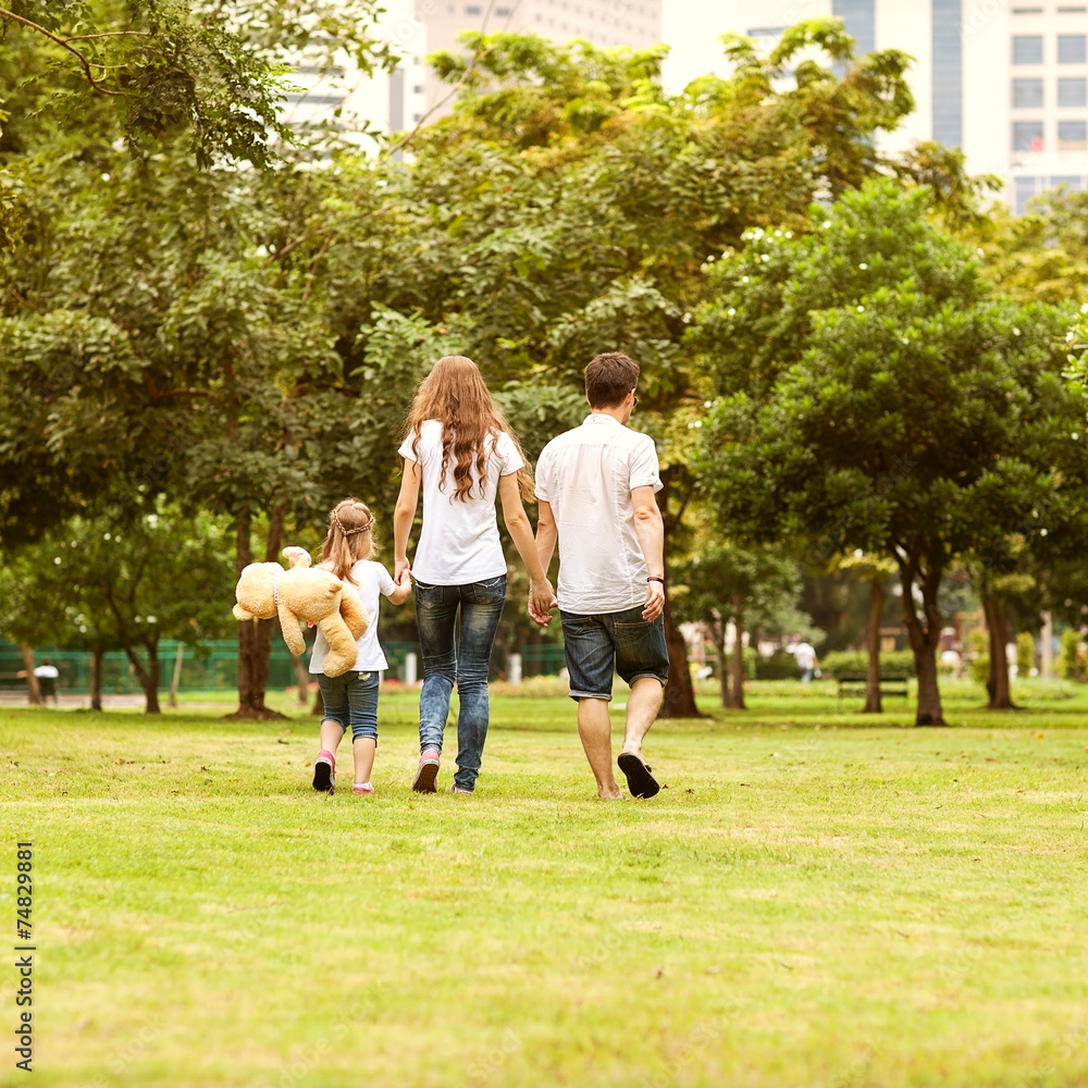 Fototapeta premium Family walk in the park, happy at sunset in Bangkok, Thailand.