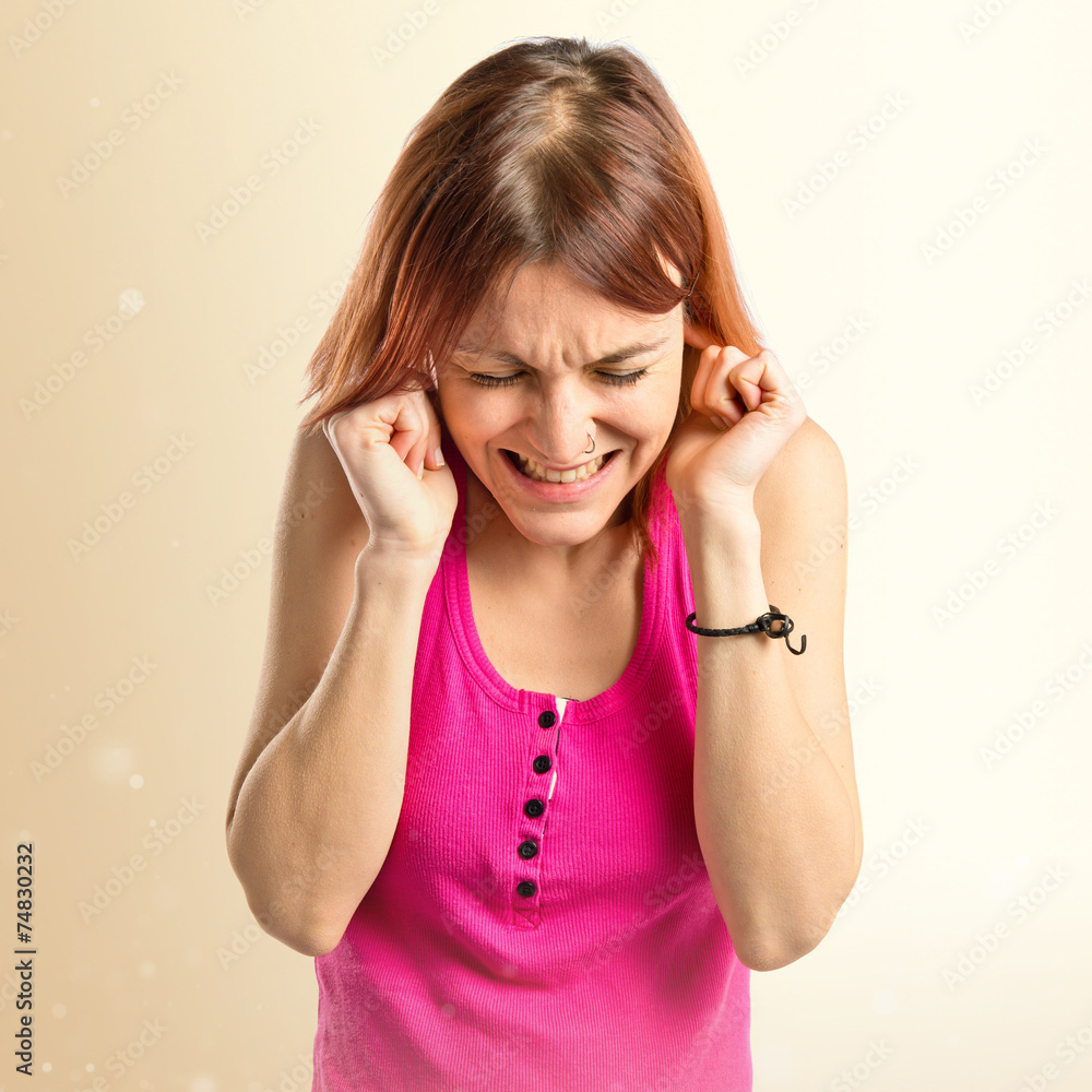 Young girl covering her ears over white background Young girl covering her ears over white background