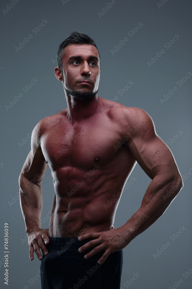 Portrait of a handsome muscular man over gray background