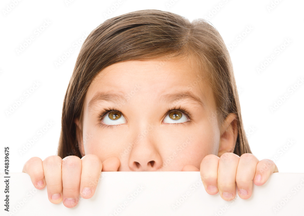 Little girl is looking from out blank board Little girl is looking from out blank board