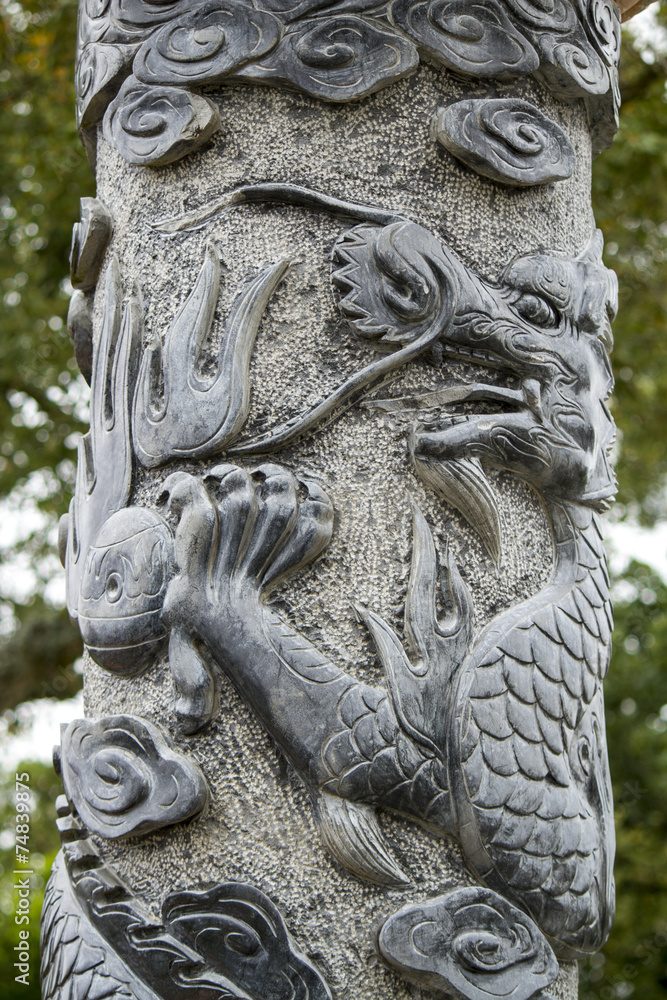 Close up view of a beautiful dragon pillar statue on a park.