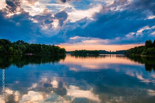 Reflection of trees and clouds at sunset in Lake Marburg, Codoru