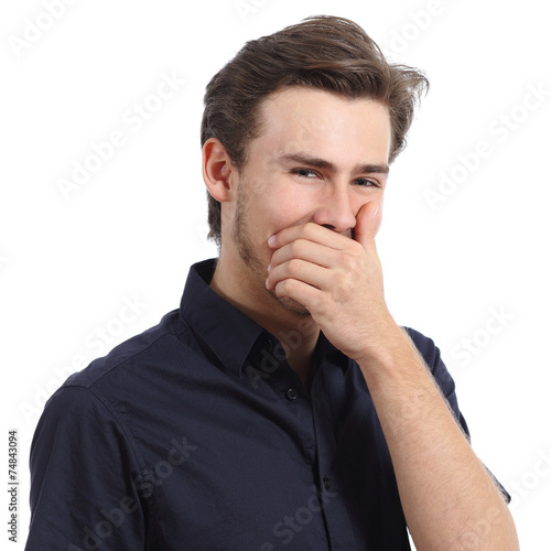 Handsome man laughing while covering his mouth with a hand