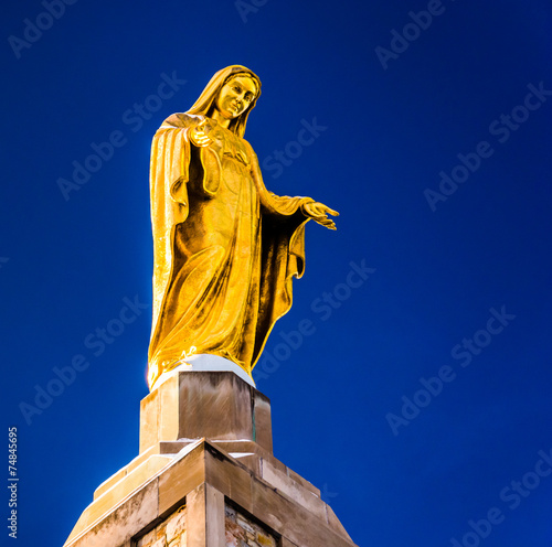 Statue on top of The National Shrine Grotto of Lourdes in Emmits photo