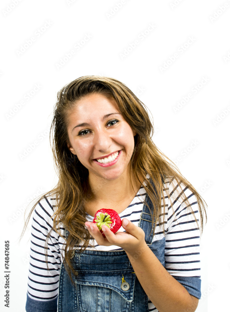 Smiling girl with sportswear holding a strawberry Smiling girl with sportswear holding a strawberry
