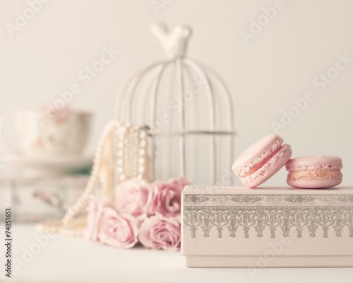 Still life with vintage roses, pearls and macaroons