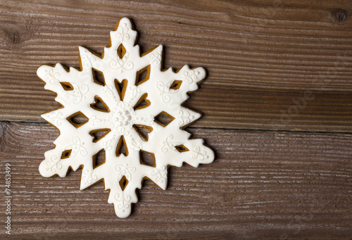 Gingerbread star on wooden background