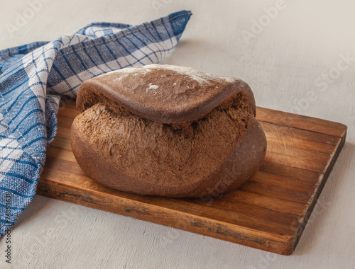 Fresh rye bread Tabatiere on the French recipe on cutting board photo