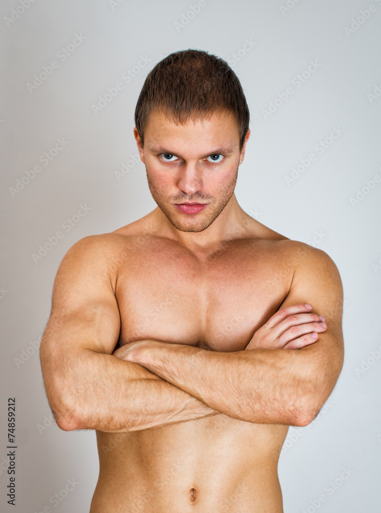 Muscular male model with arms folded. Muscular male model with arms folded.