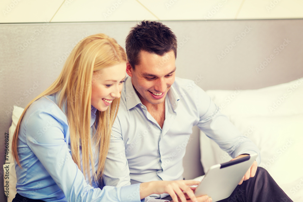 couple with tablet pc computer in hotel room couple with tablet pc computer in hotel room