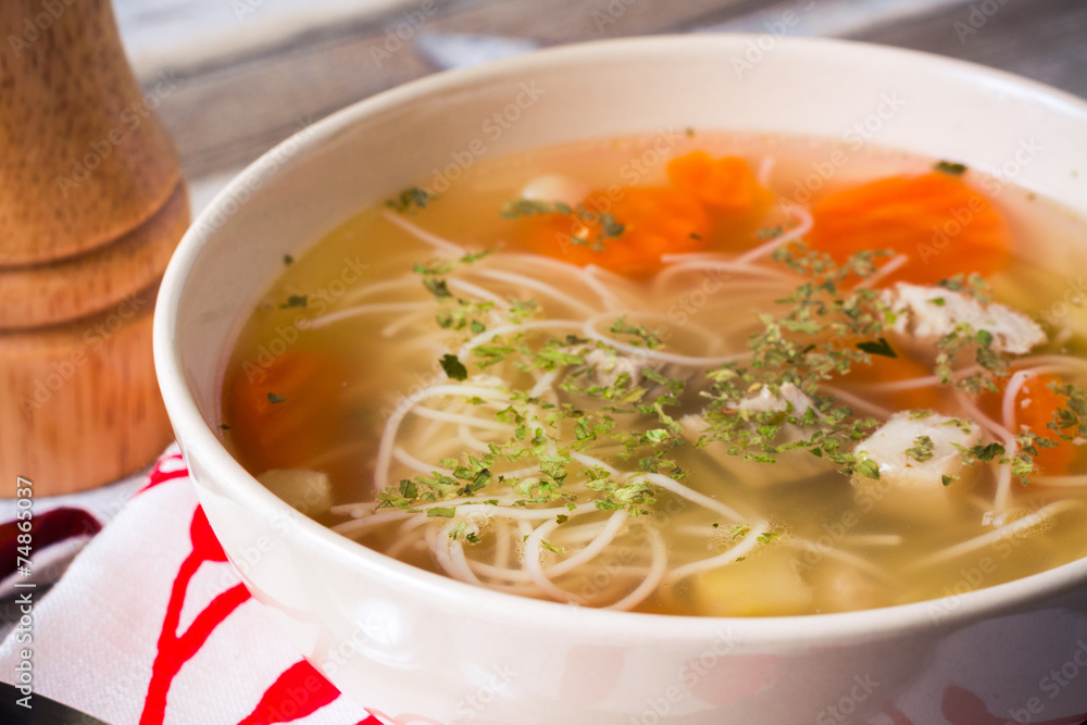 Chicken broth with vermicelli, vegetables and herbs, closeup Chicken broth with vermicelli, vegetables and herbs, closeup