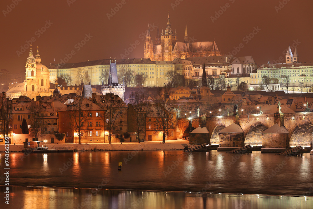 Obraz premium Night colorful snowy Prague gothic Castle with Charles Bridge