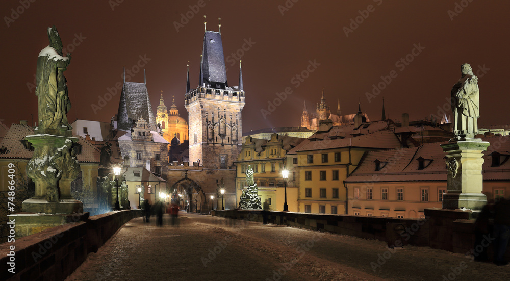 NNight snowy Prague St. Nicholas' Cathedral from Charles Bridge