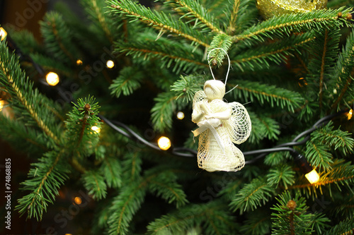 Christmas angel on christmas tree branch