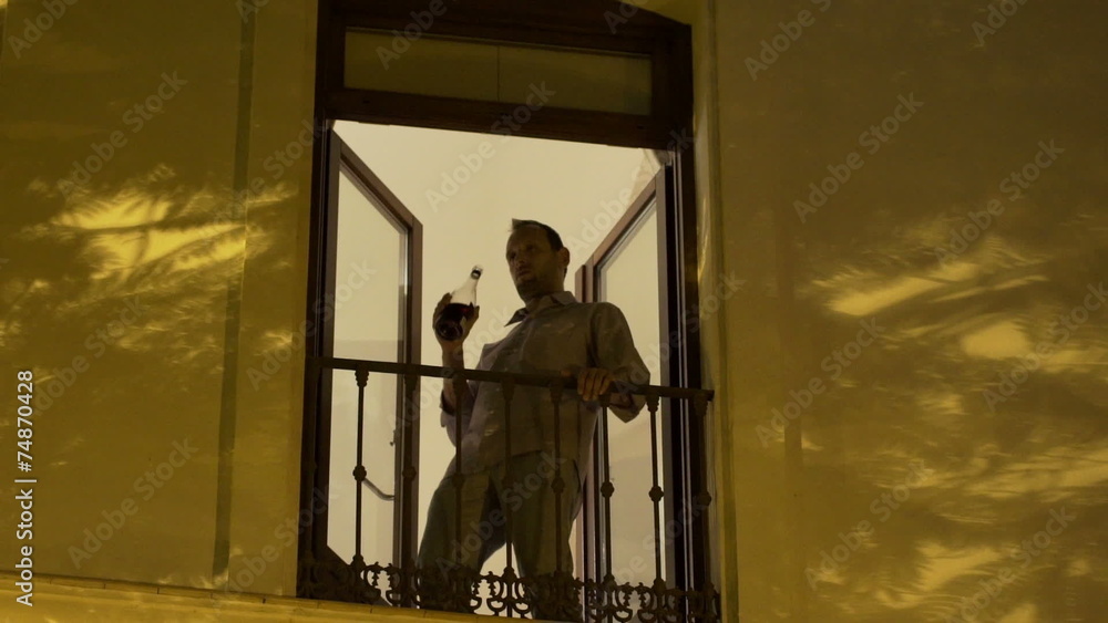 Drunk young man drinking red wine from bottle Drunk young man drinking red wine from bottle