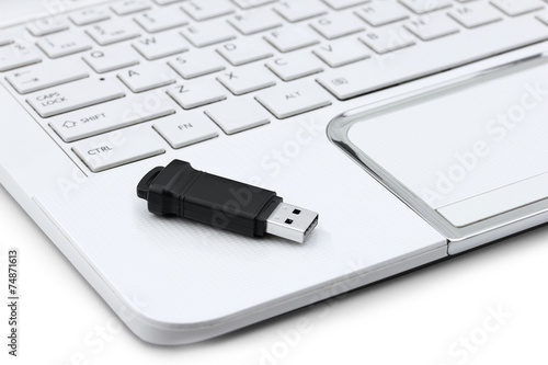 Closeup of USB Flash drive resting on laptop