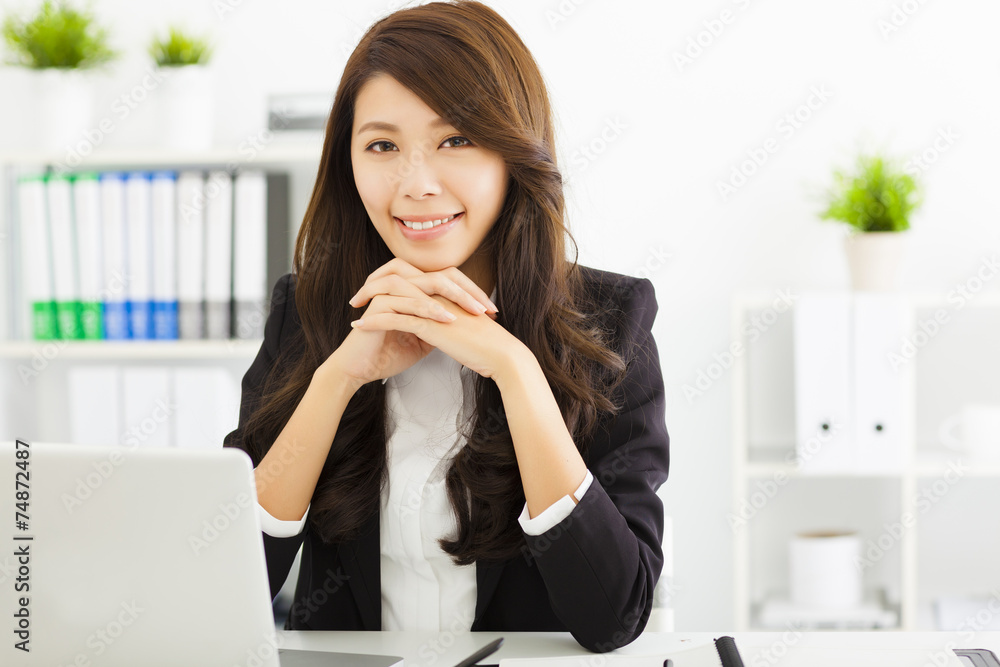 smiling young business woman working in the office smiling young business woman working in the office
