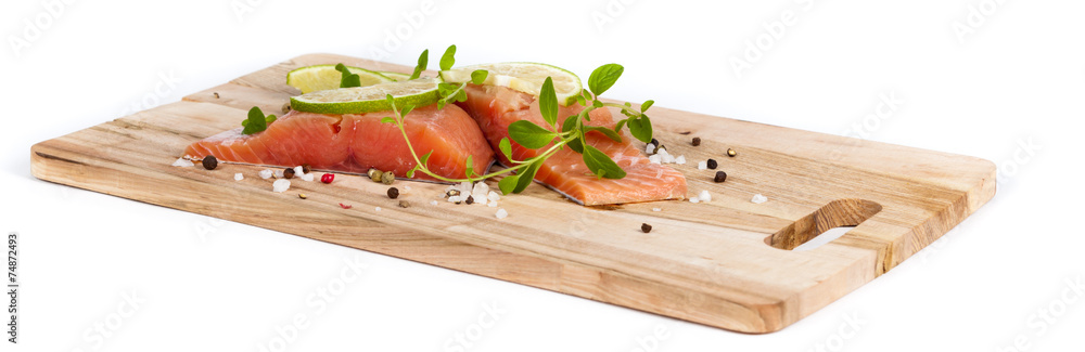 Fresh salmon fillet with oregano and lime slices Fresh salmon fillet with oregano and lime slices