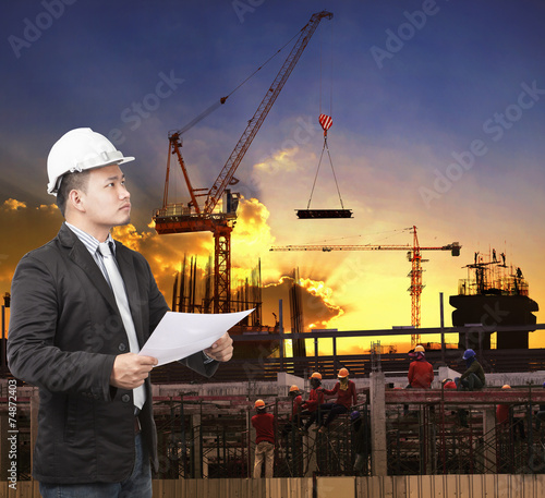 young engineer man working with construction plan in building st photo