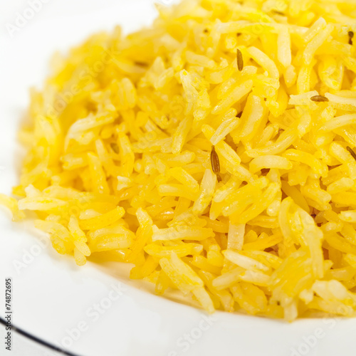 Yellow rice with cumin seeds. Selective focus.