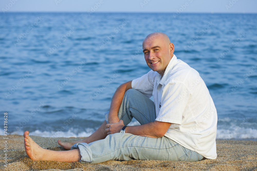  man sitting   near  sea.