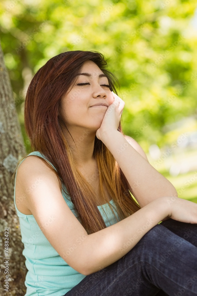 Beautiful woman with eyes closed in park Beautiful woman with eyes closed in park