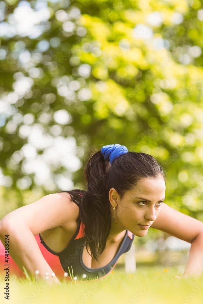 Fit determined brunette doing push ups Fit determined brunette doing push ups