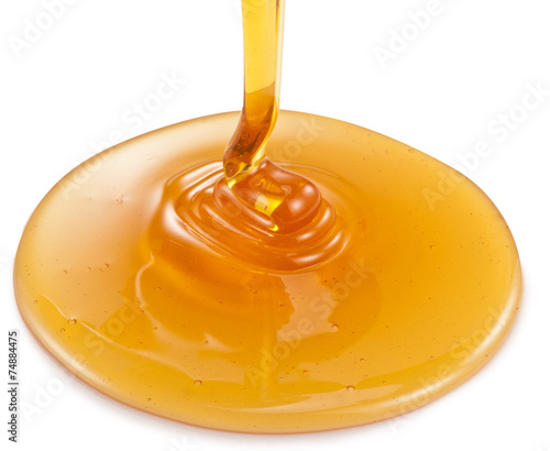 Honey flowing on white background. Clipping paths.