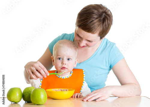 Mother spoon-feeding her baby