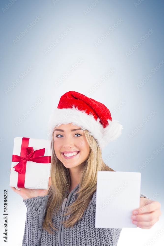 Festive blonde holding christmas gift Festive blonde holding christmas gift