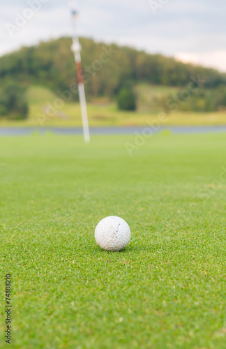 golf ball on lip of cup