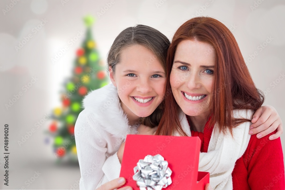Composite image of mother and daughter with gift Composite image of mother and daughter with gift