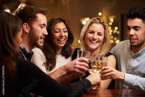 Photography Group Of Friends Enjoying Evening Drinks In Bar