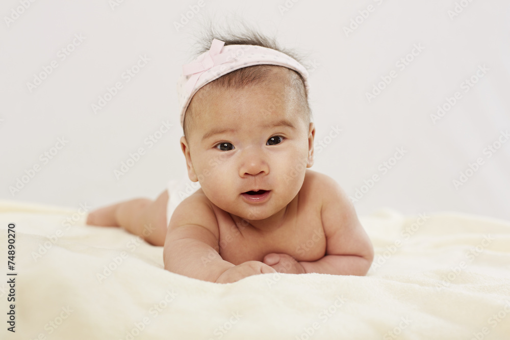 Baby liegt auf dem Bauch, frontal 2 Baby liegt auf dem Bauch, frontal 2