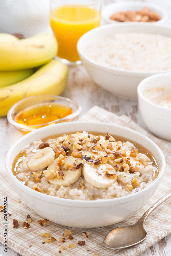 oatmeal with banana, honey and walnuts in bowl for breakfast oatmeal with banana, honey and walnuts in bowl for breakfast