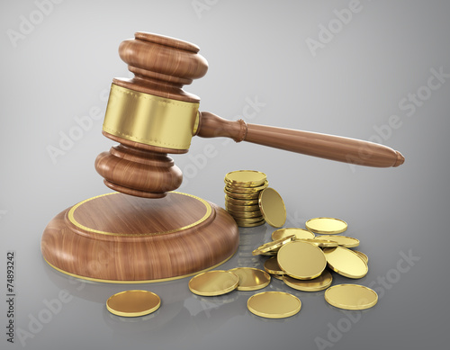 Concept of law. Wooden gavel with gold coins. photo