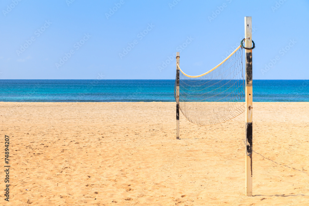 Beach Volleyball on sandy beach with sea and blue sky in the bac Beach Volleyball on sandy beach with sea and blue sky in the bac
