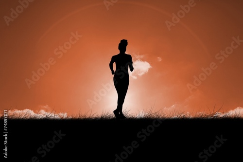 Composite image of fit brunette jogging away from camera