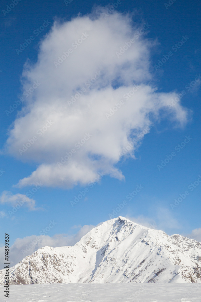 snowy mountains with clouds