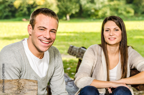 Happy young couple on a park bench