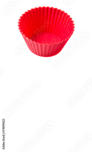 Red silicone cupcake baking cups over white background 