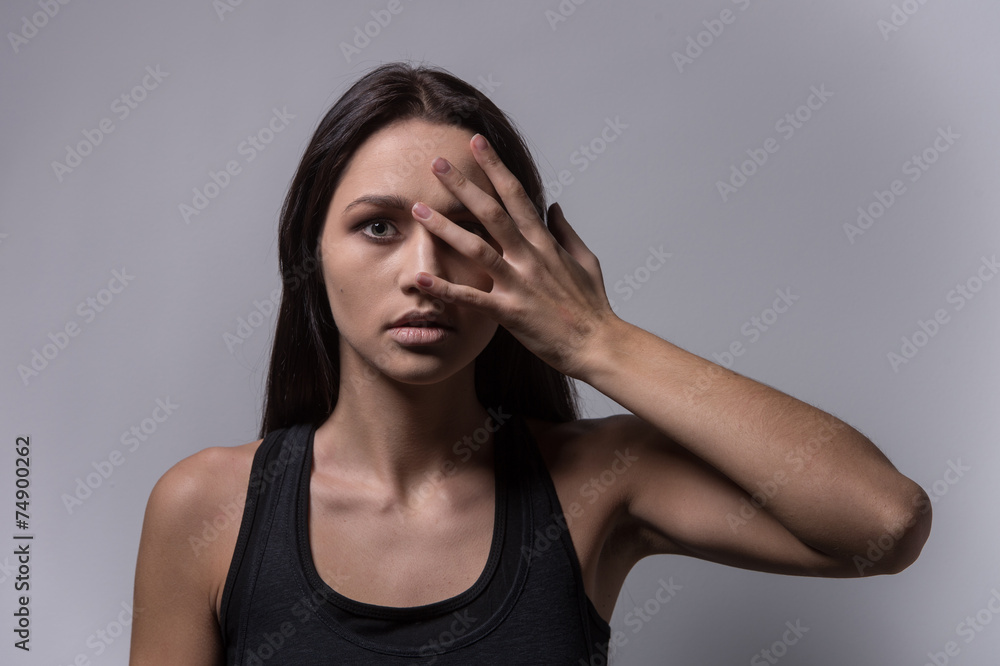 Attractive woman covering her face with both hannds. Attractive woman covering her face with both hannds.