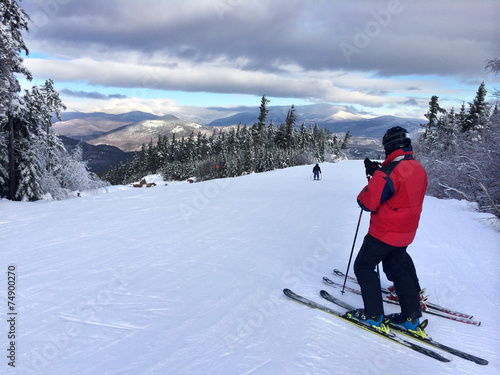 Snowy slope in the mountains with single skier