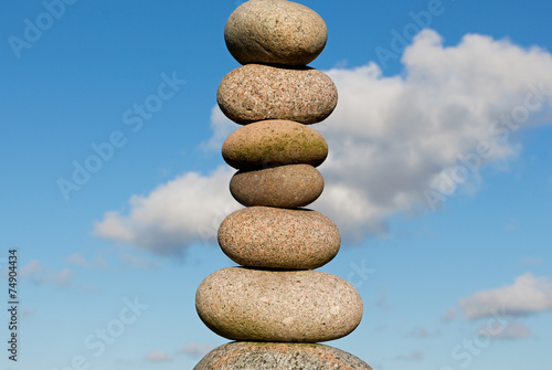 Pile of round smooth stones in sunlight