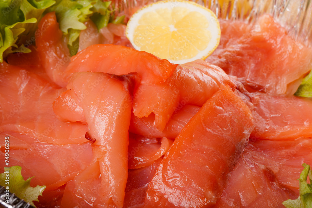 sliced salmon laid in a bowl with lemon. tinted sliced salmon laid in a bowl with lemon. tinted