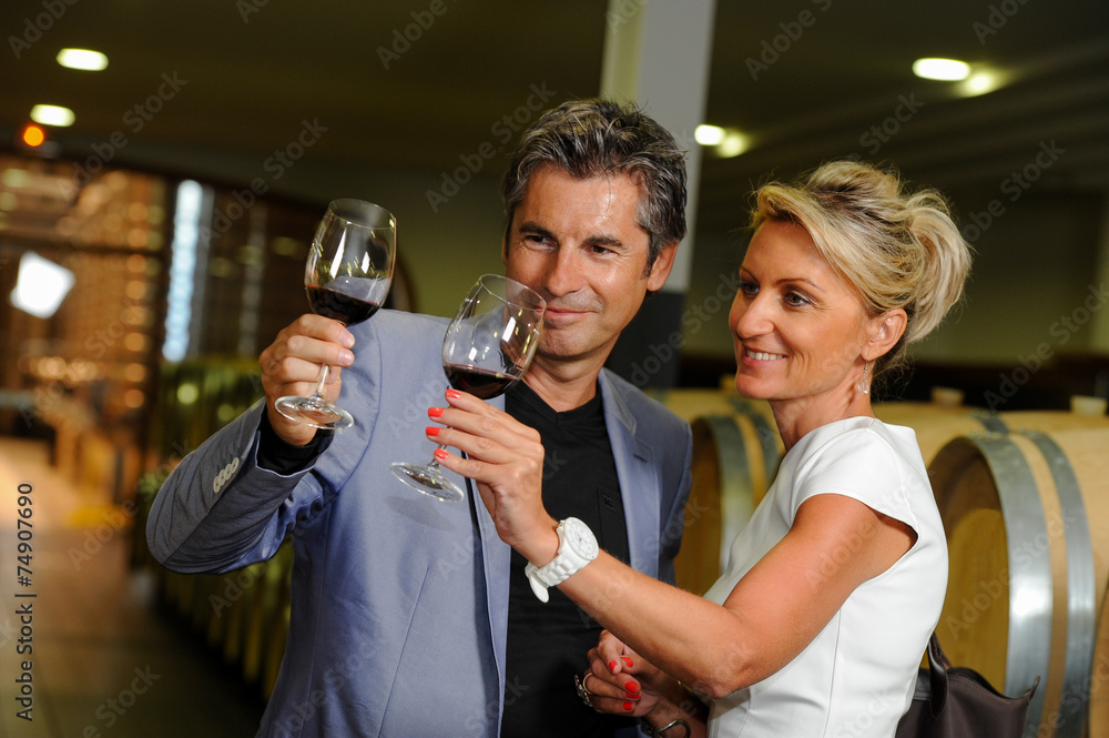 Tourism - Couple tasting wine in a cellar
